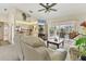 A spacious living room featuring sliding glass doors to the lanai and a view of the pool at 5258 Grassland Ter, Port Charlotte, FL 33981