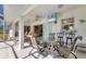 Outdoor patio area with a dining table, bar seating, and a mounted TV for entertaining at 5258 Grassland Ter, Port Charlotte, FL 33981