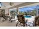 Screened-in patio with dining and lounge seating, overlooking a refreshing pool at 5258 Grassland Ter, Port Charlotte, FL 33981