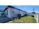 Exterior of house with green grass, a white fence, and utility installations at 5388 Montego Ln, Port Charlotte, FL 33981