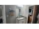 Bathroom featuring a granite vanity, modern lighting, and a view into an adjacent bedroom at 5388 Montego Ln, Port Charlotte, FL 33981