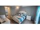 Cozy bedroom with a white-painted bed frame, striped bedding, and ensuite bathroom at 5388 Montego Ln, Port Charlotte, FL 33981