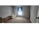 This cozy bedroom offers plush carpet flooring and a window letting in natural light at 5388 Montego Ln, Port Charlotte, FL 33981