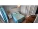 Comfortable bedroom with closet space, light blue bedspread, a nightstand with a lamp, and a ceiling fan at 5388 Montego Ln, Port Charlotte, FL 33981