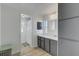 Elegant bathroom featuring a modern vanity with gray cabinets and a glimpse into the shower area at 5619 Bayshore Rd # 240, Palmetto, FL 34221