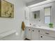 Clean bathroom featuring white cabinets, laminate countertop, neutral wall art, and modern fixtures at 5619 Bayshore Rd # 240, Palmetto, FL 34221