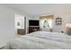 Bright bedroom featuring a large bed, window with curtains, and a TV on a wooden dresser at 5619 Bayshore Rd # 240, Palmetto, FL 34221