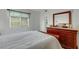 Bright bedroom with white walls, wood trim, dresser, and window with wooden blinds at 5619 Bayshore Rd # 240, Palmetto, FL 34221