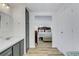 Hallway with a bathroom and bedroom featuring modern vanity, bedroom, and wooden floors at 5619 Bayshore Rd # 240, Palmetto, FL 34221