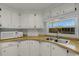 Well-lit kitchen featuring white cabinets, modern appliances, and a stainless-steel sink at 5619 Bayshore Rd # 240, Palmetto, FL 34221