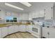 Clean kitchen with white cabinets and a stainless-steel sink for preparing delicious meals at 5619 Bayshore Rd # 240, Palmetto, FL 34221