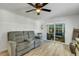 Comfortable living room featuring wood-look flooring, neutral paint, a ceiling fan and a view of the lanai at 5619 Bayshore Rd # 240, Palmetto, FL 34221