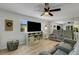 Cozy living room with a large television, light-toned floors, and a comfortable gray sofa at 5619 Bayshore Rd # 240, Palmetto, FL 34221