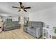 Bright living room featuring wood-look floors, modern fan, neutral paint, and comfortable seating at 5619 Bayshore Rd # 240, Palmetto, FL 34221