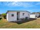 The rear exterior of this home, featuring the utility connections and minimal landscaping at 5619 Bayshore Rd # 240, Palmetto, FL 34221