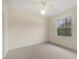 Bright, carpeted bedroom with a ceiling fan and a window for natural lighting at 5800 Monroe Rd, Venice, FL 34293