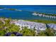 Aerial view of a white condominium complex near a marina and bridge with lush landscaping and palm trees at 5858 Gasparilla Rd # Mm40, Boca Grande, FL 33921