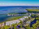 An aerial shot of a condo complex with a marina and pool, with a stunning view of the ocean at 5858 Gasparilla Rd # Mm40, Boca Grande, FL 33921