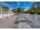 Pool deck features white chairs, umbrellas, and beautiful views of nature and a relaxing atmosphere at 5858 Gasparilla Rd # Mm40, Boca Grande, FL 33921