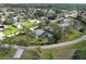 Beautiful aerial view of home featuring mature trees, landscaping, and large corner lot at 587 Viridian St, Englewood, FL 34223