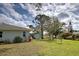 Expansive backyard with lush lawn, mature trees, shed, and room for outdoor activities at 587 Viridian St, Englewood, FL 34223