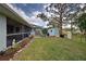 Backyard featuring a screened lanai, shed, and well-kept lawn for outdoor enjoyment at 587 Viridian St, Englewood, FL 34223