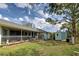 Expansive backyard featuring a screened porch, shed, outdoor shower, and lush landscaping for outdoor enjoyment at 587 Viridian St, Englewood, FL 34223