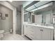 Bright bathroom featuring a double sink vanity, walk-in shower, and tiled floors at 587 Viridian St, Englewood, FL 34223