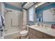 Bathroom featuring a shower-tub combination, a window, and a vanity with sink at 587 Viridian St, Englewood, FL 34223