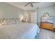 This bedroom features wood-look flooring, a ceiling fan, and natural light at 587 Viridian St, Englewood, FL 34223