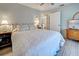 This bedroom features wood-look flooring, a ceiling fan, and neutral colored walls at 587 Viridian St, Englewood, FL 34223