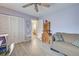 This bedroom features tile floors, a ceiling fan, closet space, and a neutral color scheme at 587 Viridian St, Englewood, FL 34223