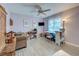 Comfortable bedroom featuring a ceiling fan, tiled floors, and a cozy seating area with natural light at 587 Viridian St, Englewood, FL 34223