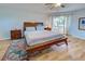 This bedroom features wood floors, natural light, and space for nightstands at 587 Viridian St, Englewood, FL 34223