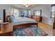 This bedroom features wood floors, natural light, a ceiling fan, and a walk-in closet at 587 Viridian St, Englewood, FL 34223