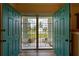 Inviting foyer with double front doors, security gate, and a view of the landscaped yard at 587 Viridian St, Englewood, FL 34223