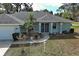 Close up of charming home with lush landscaping; a welcoming entry to your new home at 587 Viridian St, Englewood, FL 34223