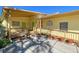 Charming yellow building with a wooden porch and ramp, surrounded by potted plants at 587 Viridian St, Englewood, FL 34223