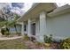 Covered front porch with decorative accents and landscaping, offering a welcoming first impression at 587 Viridian St, Englewood, FL 34223
