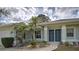 Inviting front entrance with colorful plants, decorative stone and secure double entry doors at 587 Viridian St, Englewood, FL 34223