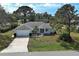 Charming single-story home with well-maintained lawn and landscaping at 587 Viridian St, Englewood, FL 34223
