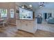 Open-concept kitchen with granite island flows into a living area with modern decor and wood-look tile flooring at 587 Viridian St, Englewood, FL 34223