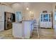 Well-lit kitchen features granite countertops, breakfast bar seating, and stainless steel refrigerator at 587 Viridian St, Englewood, FL 34223