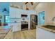 Modern kitchen design with white cabinetry, stainless steel appliances, and granite countertops at 587 Viridian St, Englewood, FL 34223