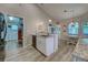 Bright kitchenette boasts granite countertops and stainless steel dishwasher, plus adjacent dining area at 587 Viridian St, Englewood, FL 34223
