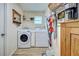 Clean and functional laundry room with modern appliances, storage shelves, and well-organized cleaning supplies at 587 Viridian St, Englewood, FL 34223