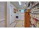 Well-equipped laundry room featuring modern washer/dryer units and ample storage shelving at 587 Viridian St, Englewood, FL 34223