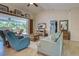 Bright and airy living room features wood-look tile floors and sliders to outdoor seating area at 587 Viridian St, Englewood, FL 34223