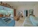 Open living room showcases vaulted ceiling, wood-look tile floors and sliders to outdoor seating area at 587 Viridian St, Englewood, FL 34223