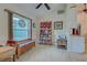 Bright, airy living room with wood-look tile flooring and ample natural light from stained glass window at 587 Viridian St, Englewood, FL 34223